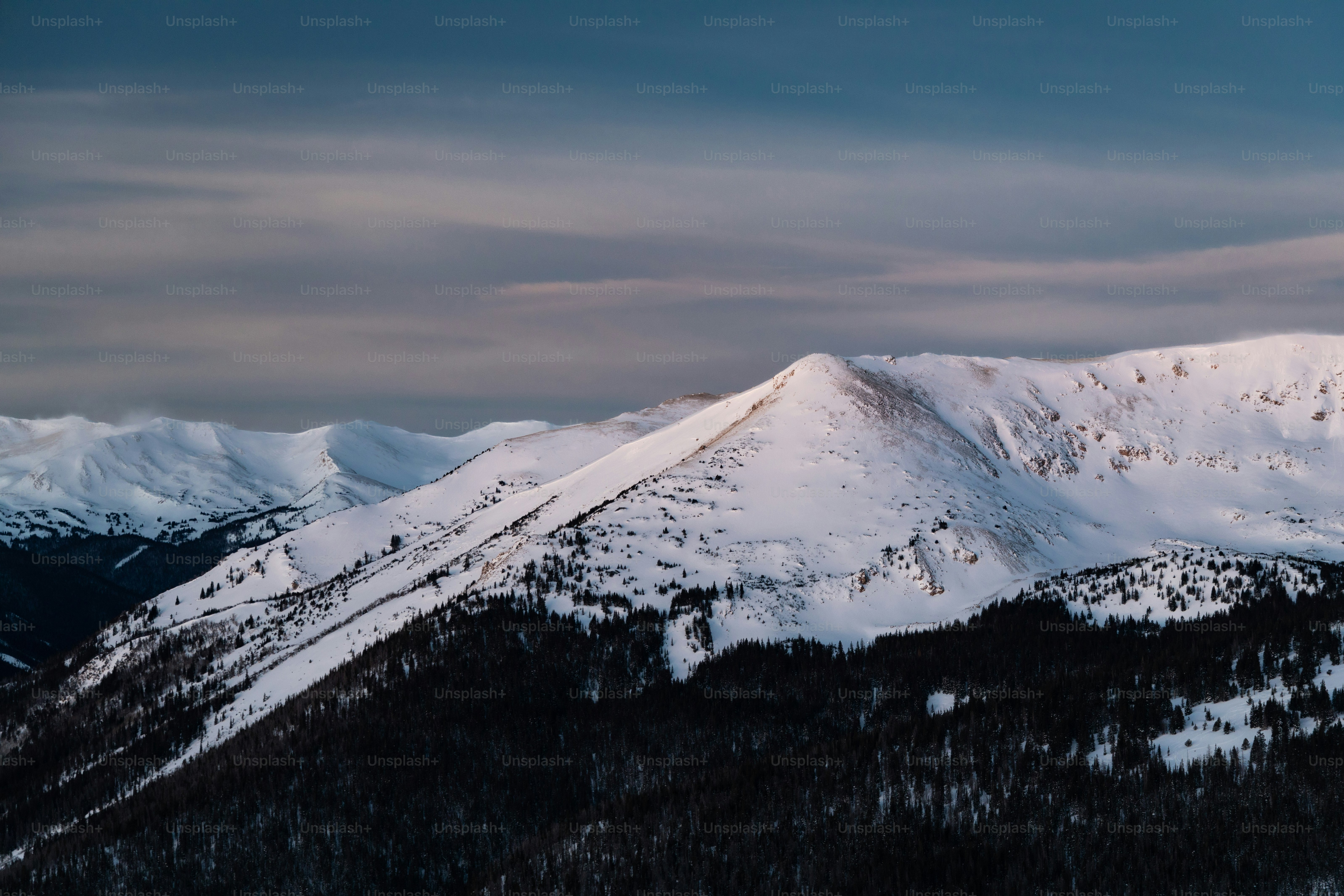 a view of a mountain range with snow on it