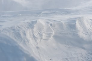 a man riding skis down the side of a snow covered slope