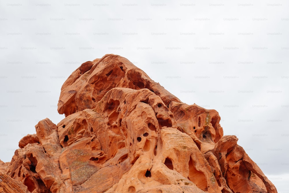 a large rock formation with a sky background