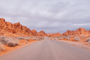 a road in the middle of a desert with mountains in the background