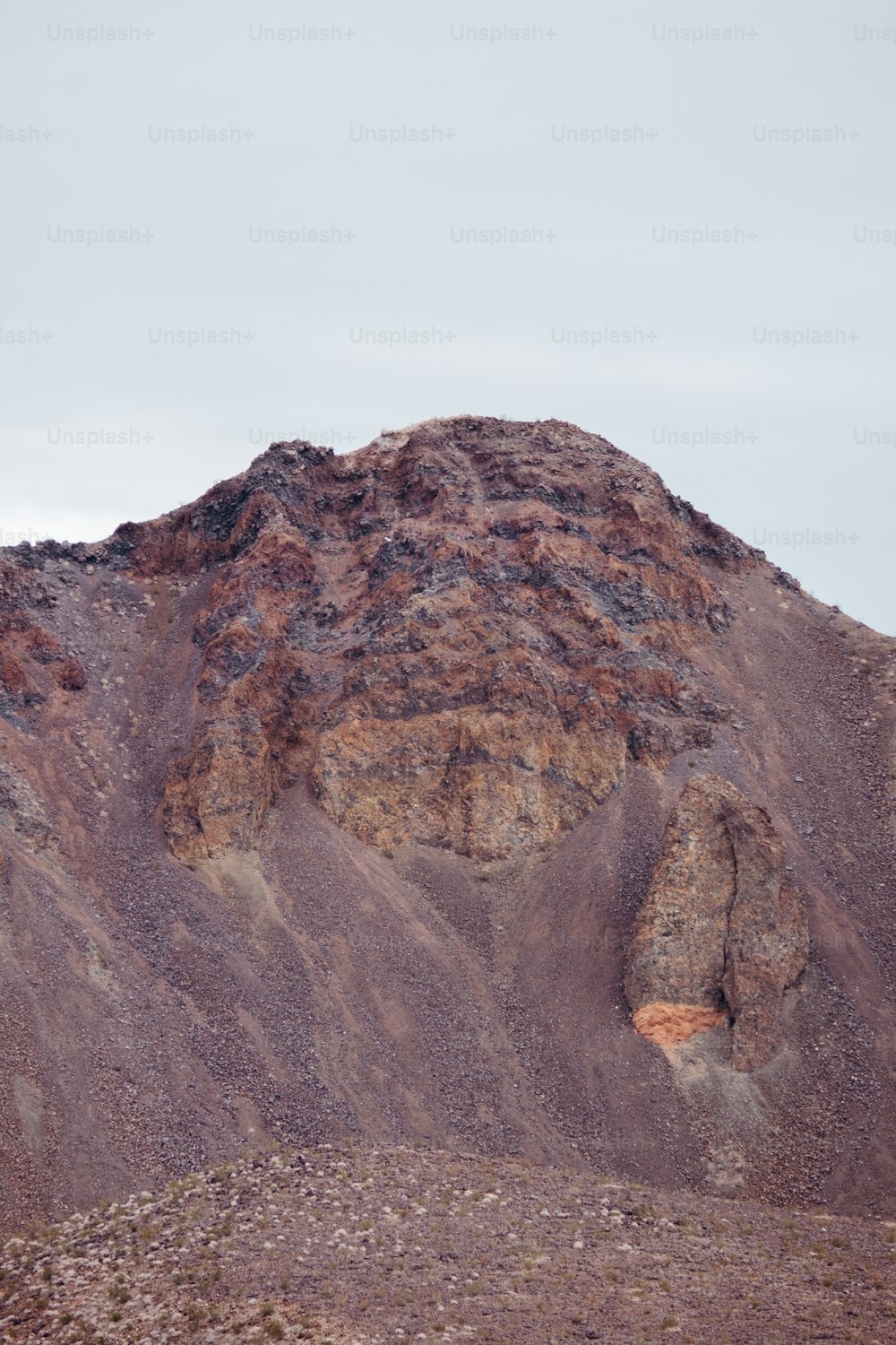 a large mountain with a very tall rock face