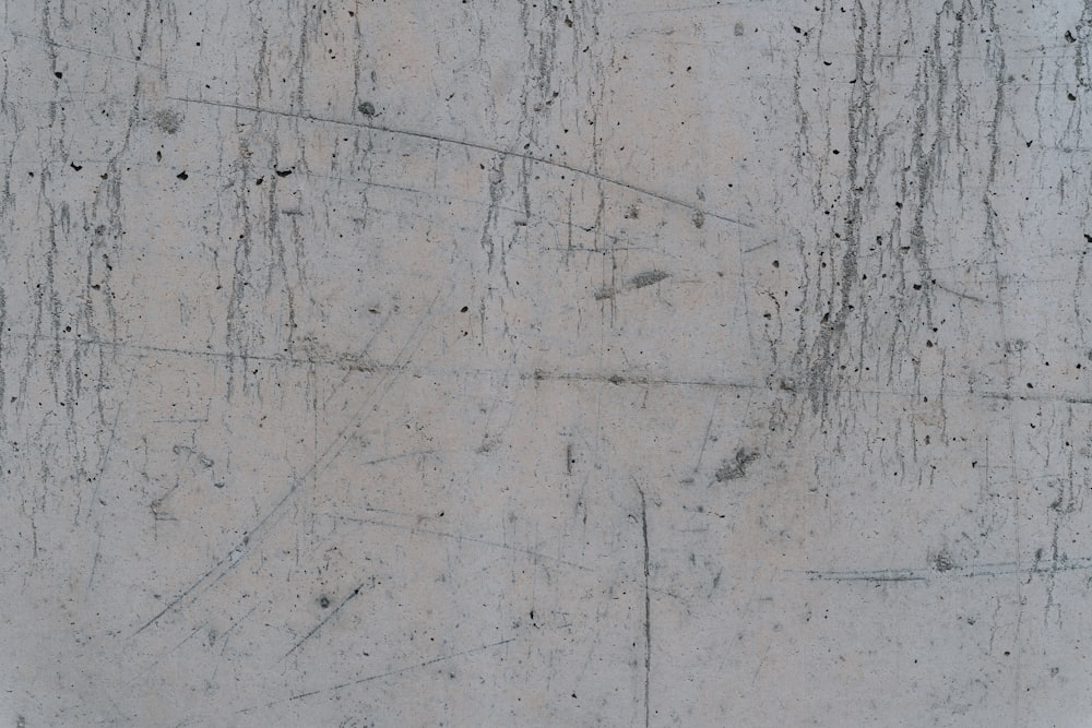 a close up of a concrete wall with cracks