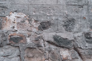 a stone wall with a clock on it