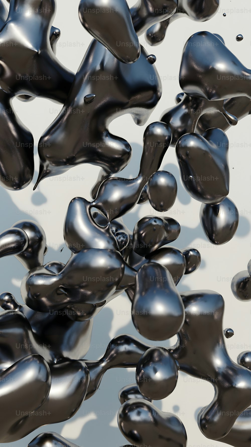 a bunch of black balloons floating in the air