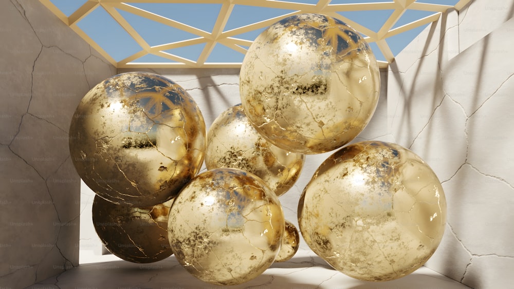 a bunch of shiny gold balls hanging from a ceiling