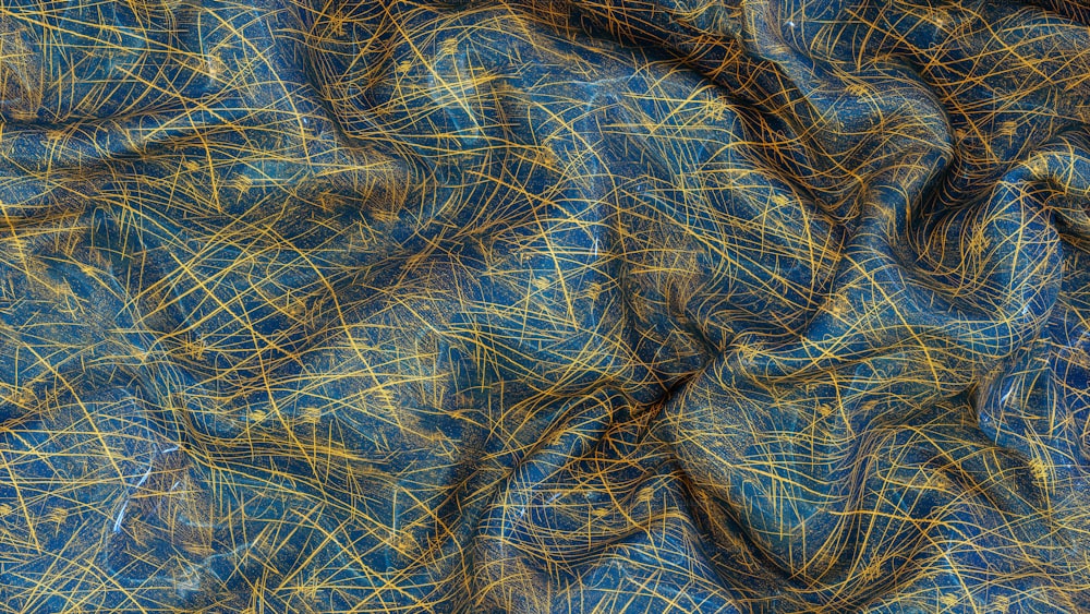 a close up of a blue and gold cloth