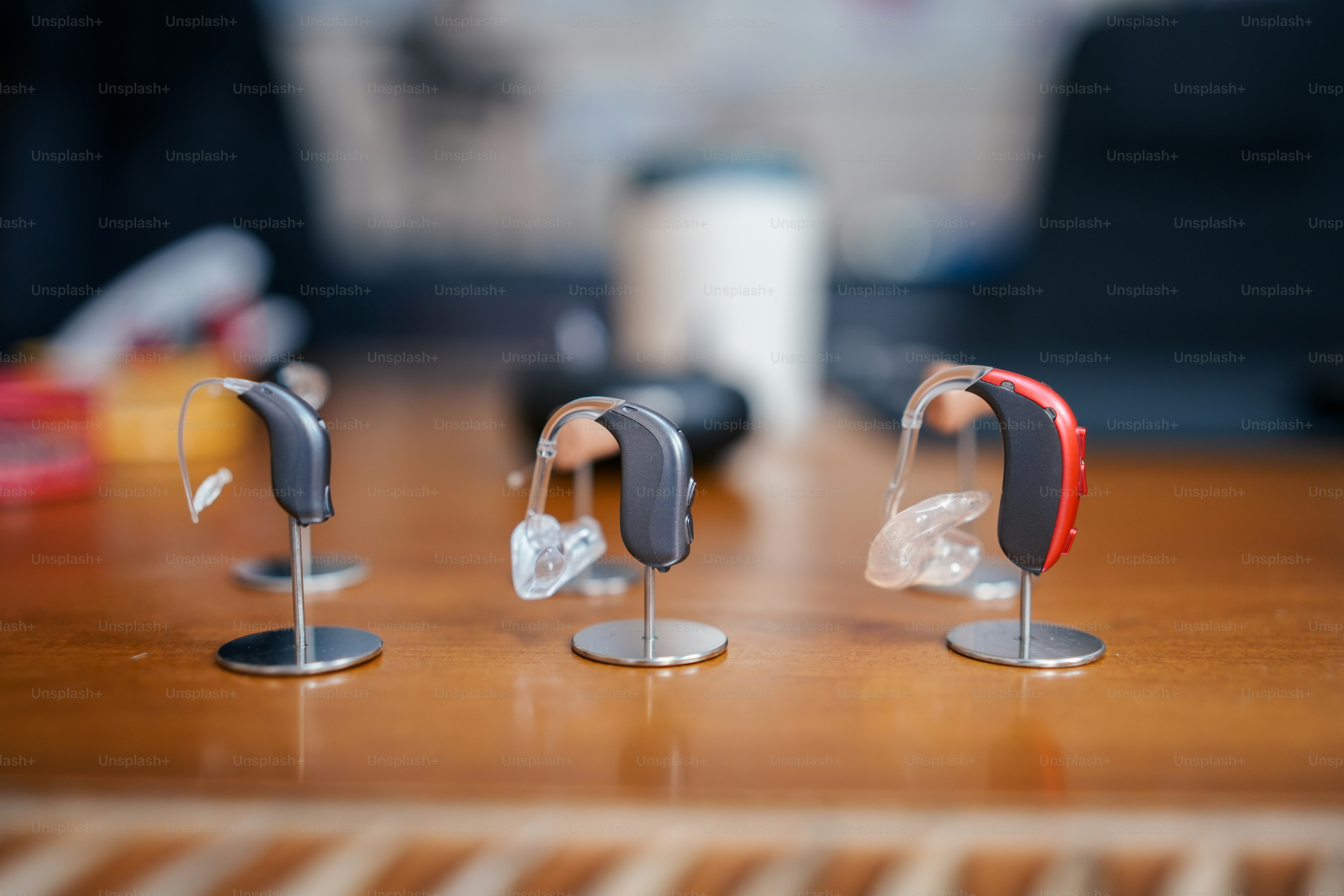 a group of three pieces of plastic sitting on top of a wooden table