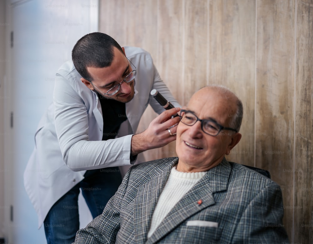 a man getting his hair cut by a man in a suit