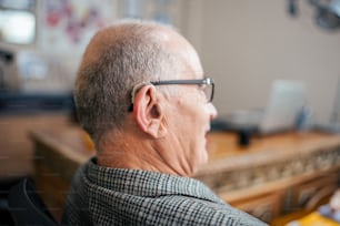 a man with glasses sitting at a desk