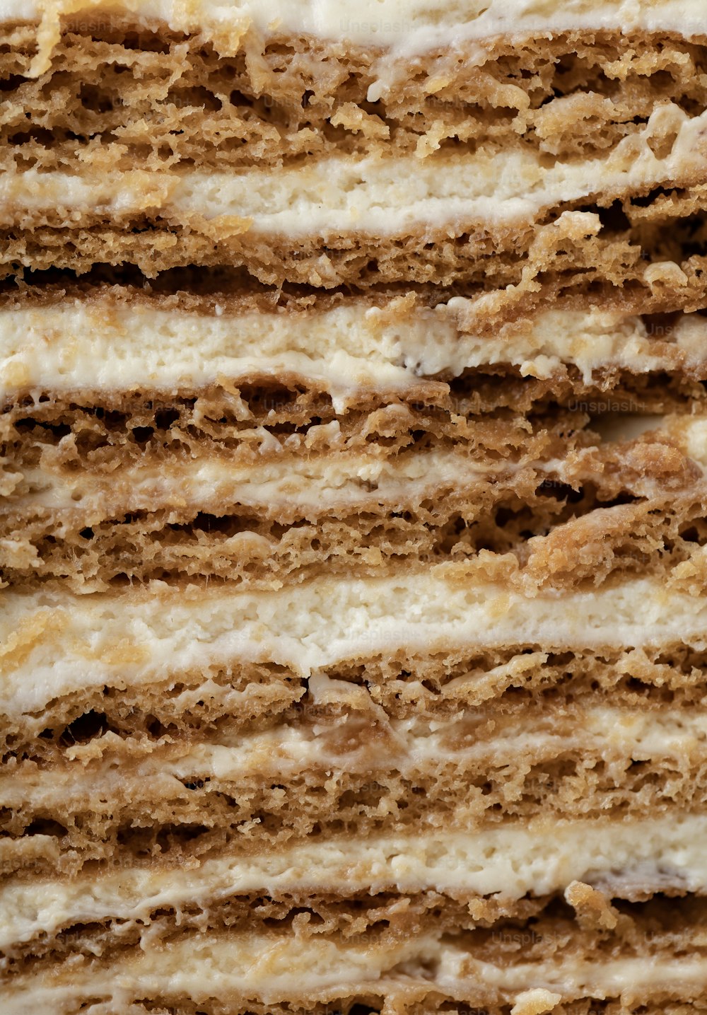 a close up of a cake with white frosting