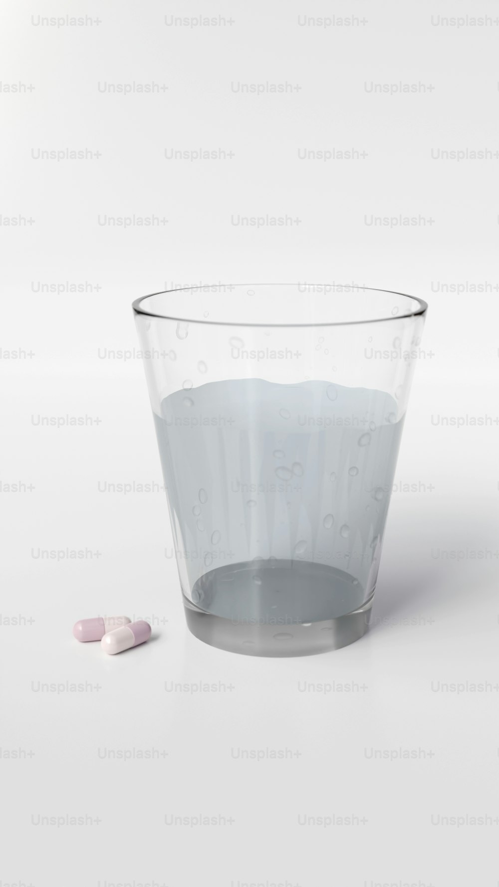 a glass filled with water and two pills