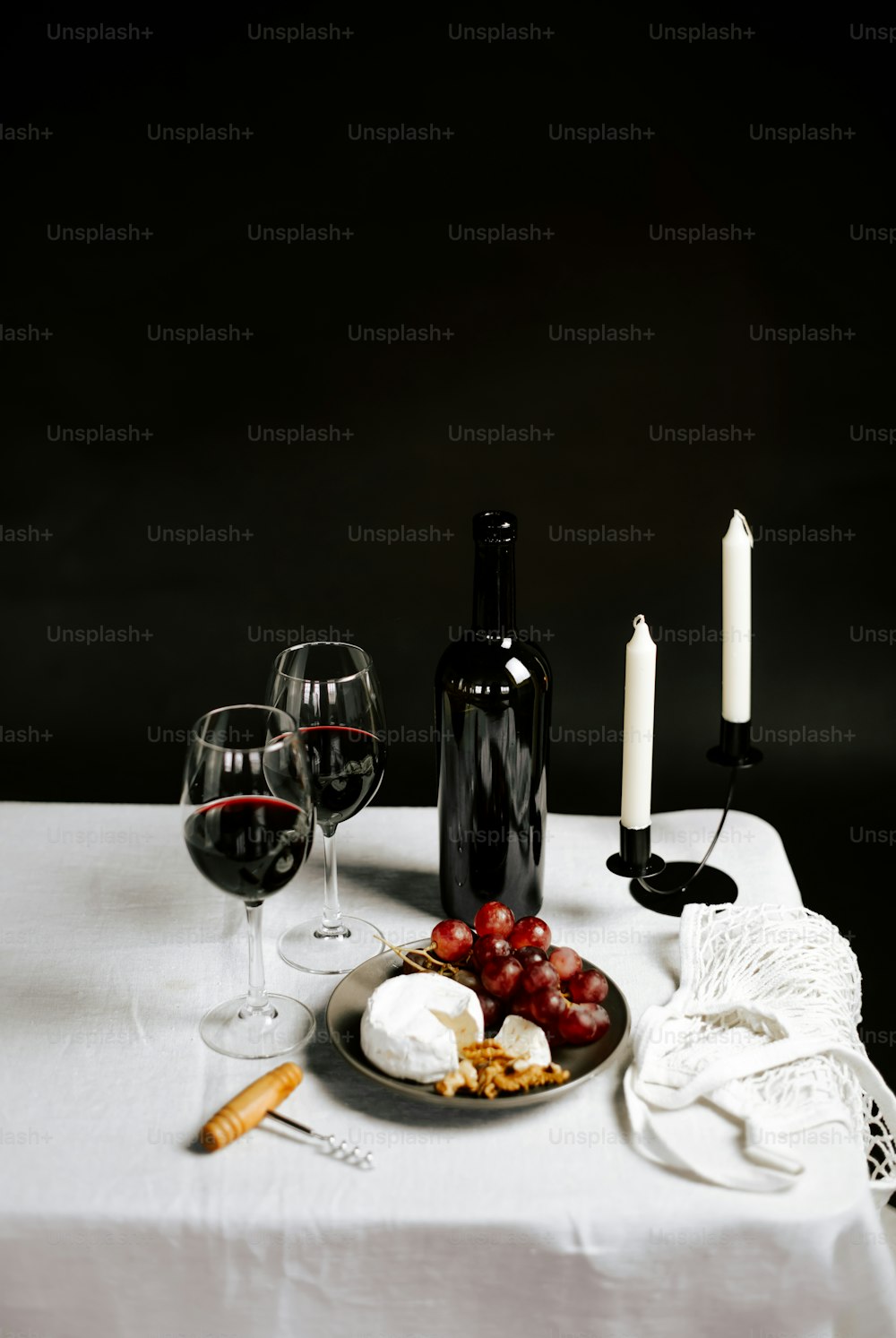 a plate of food and two wine glasses on a table