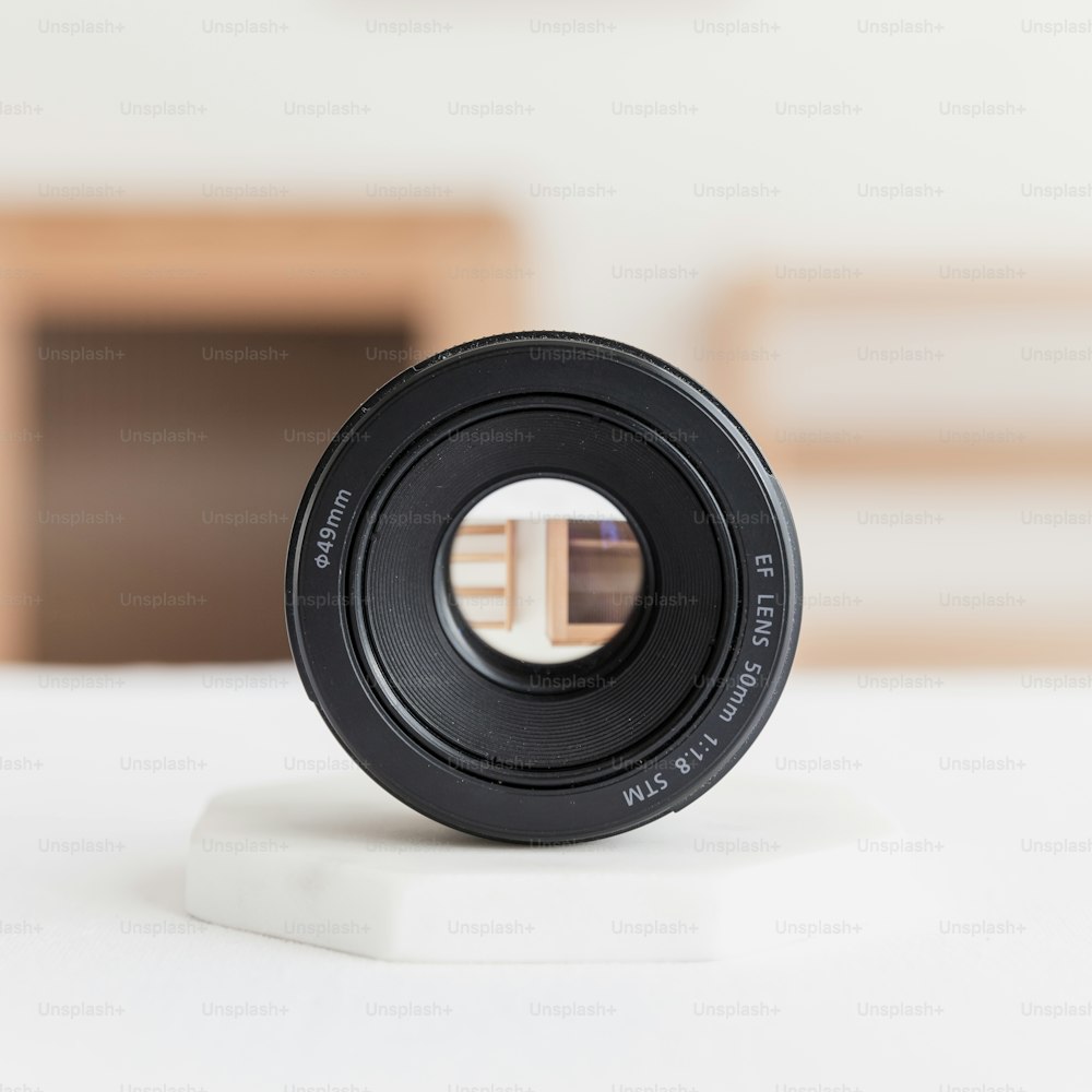 a camera lens sitting on top of a white table