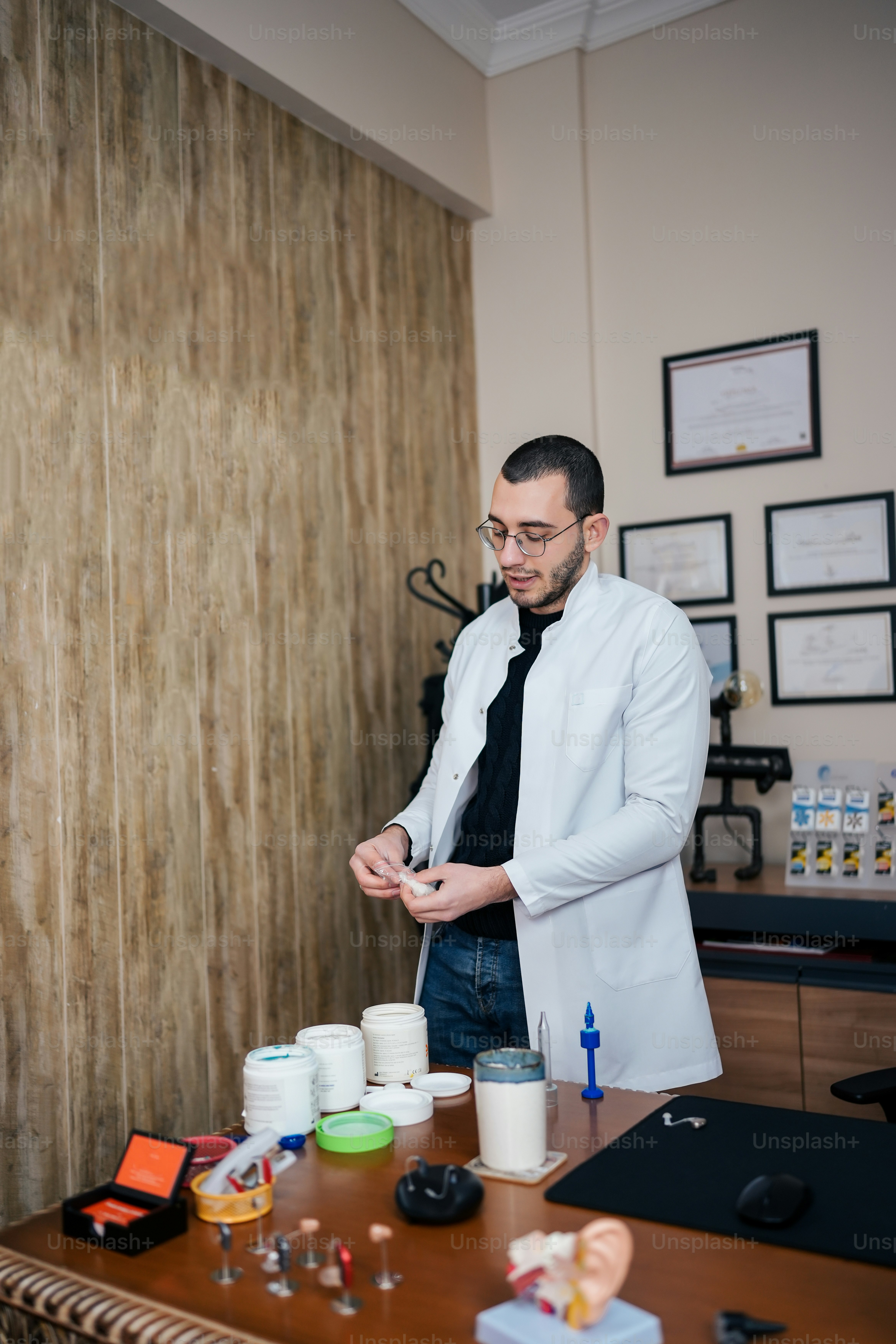 a man in a white coat and black tie