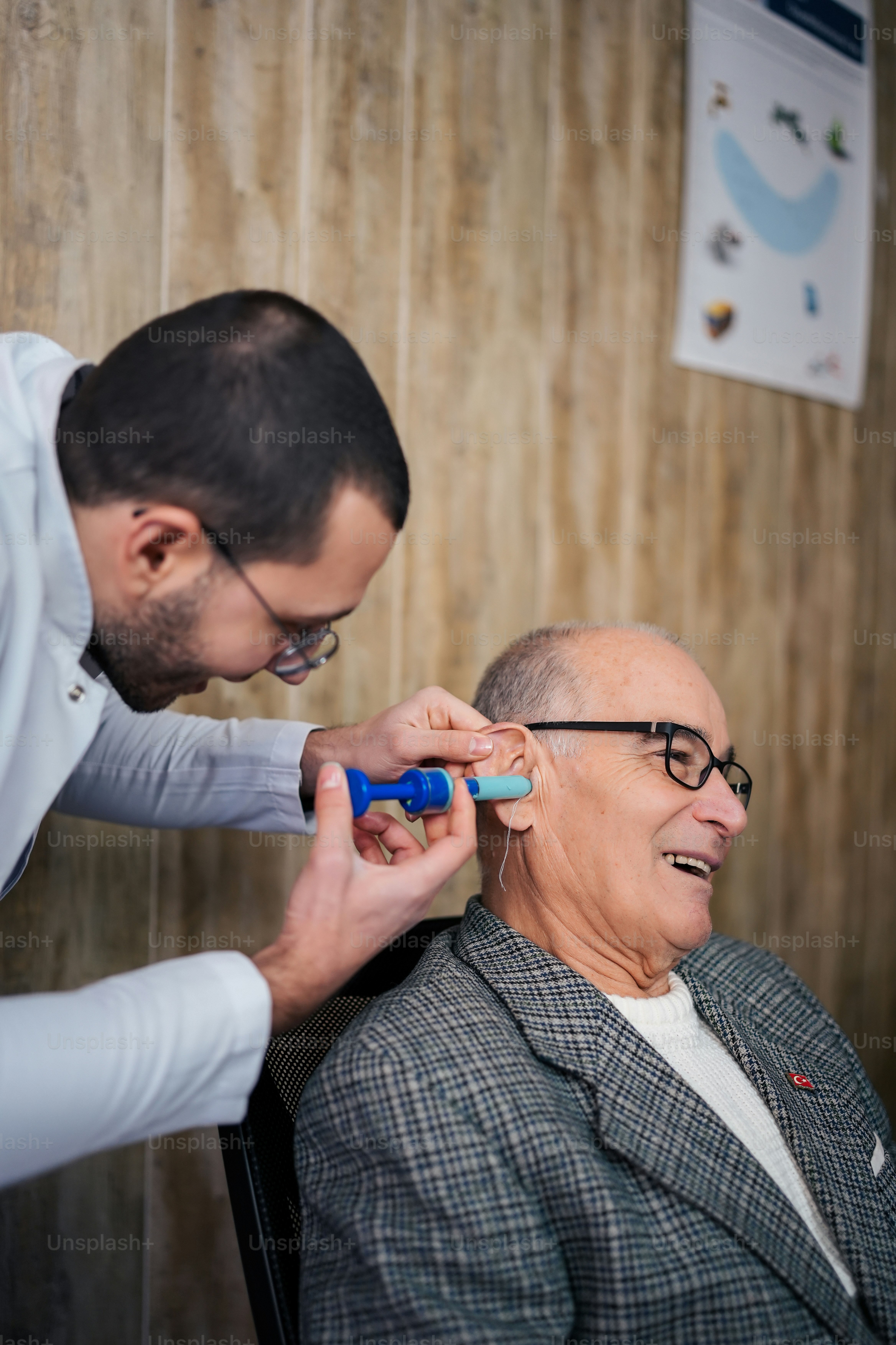 a man getting his hair cut by a man in a chair