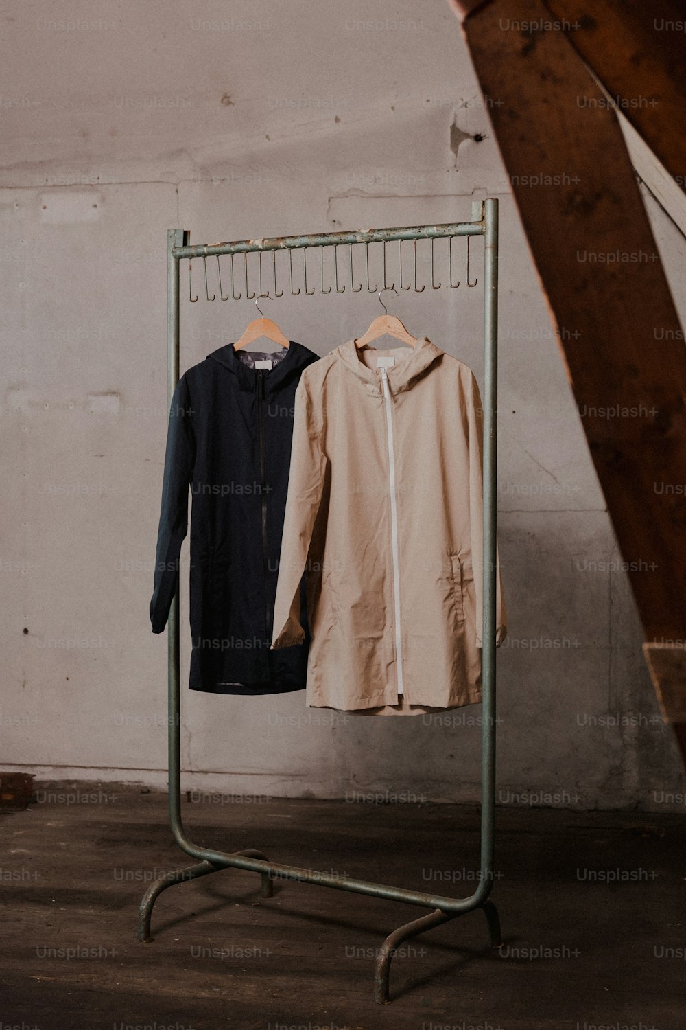 a pair of jackets hanging on a clothes rack