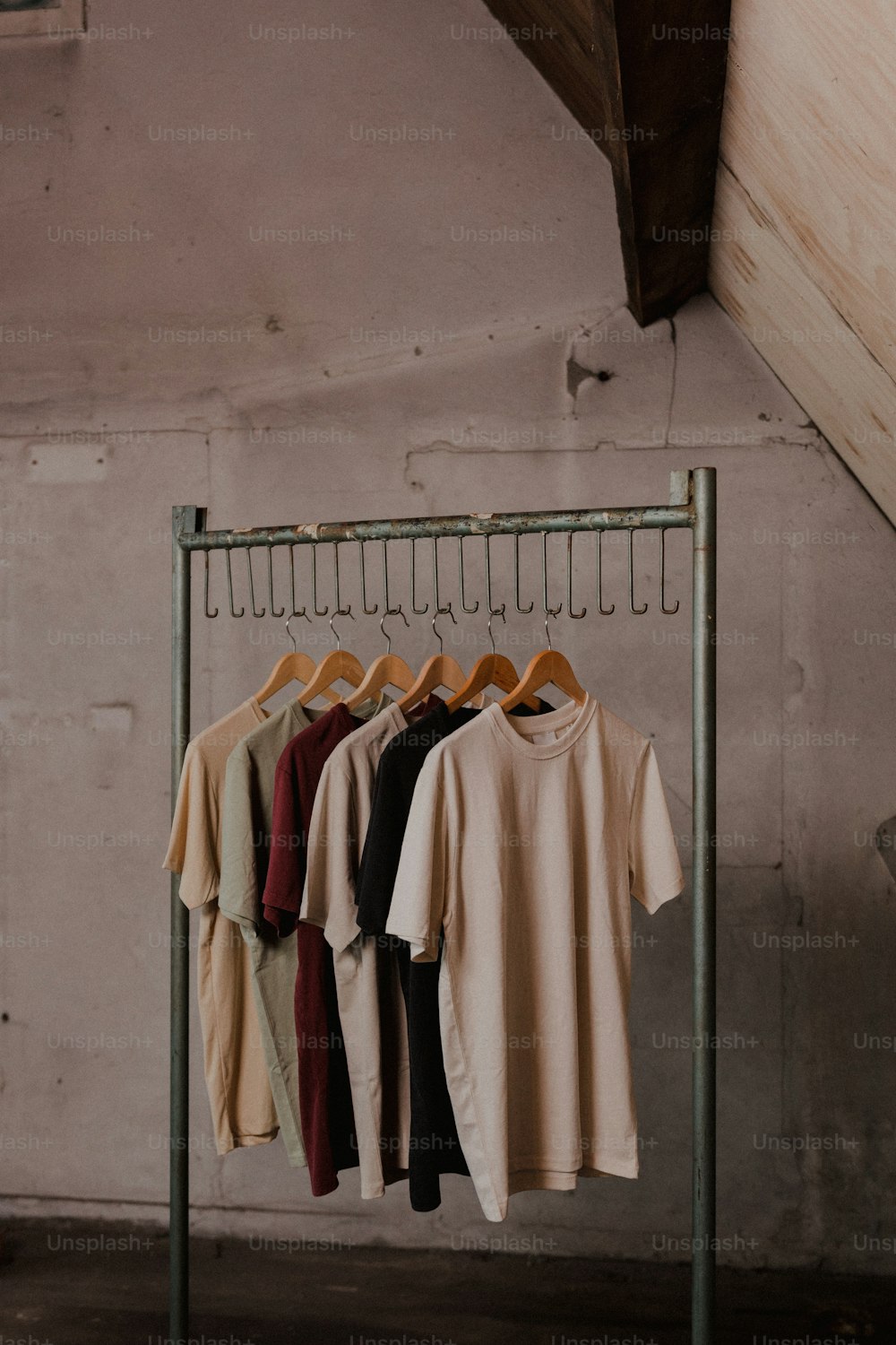 a rack of t - shirts hanging on a clothes rack