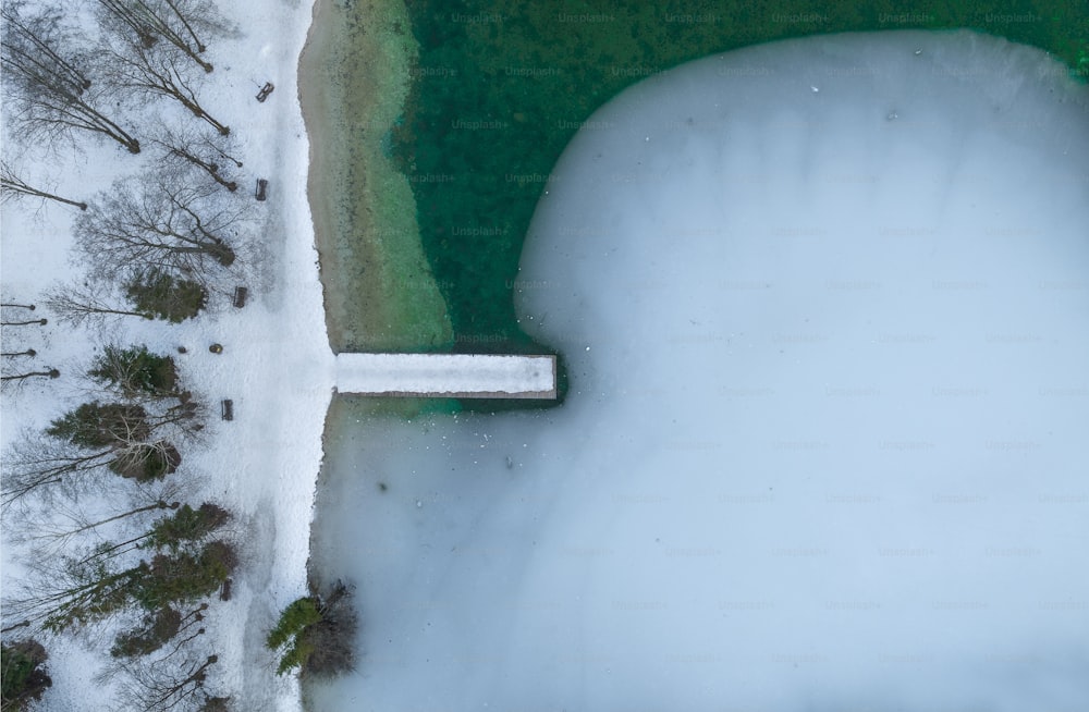 an aerial view of a snow covered lake