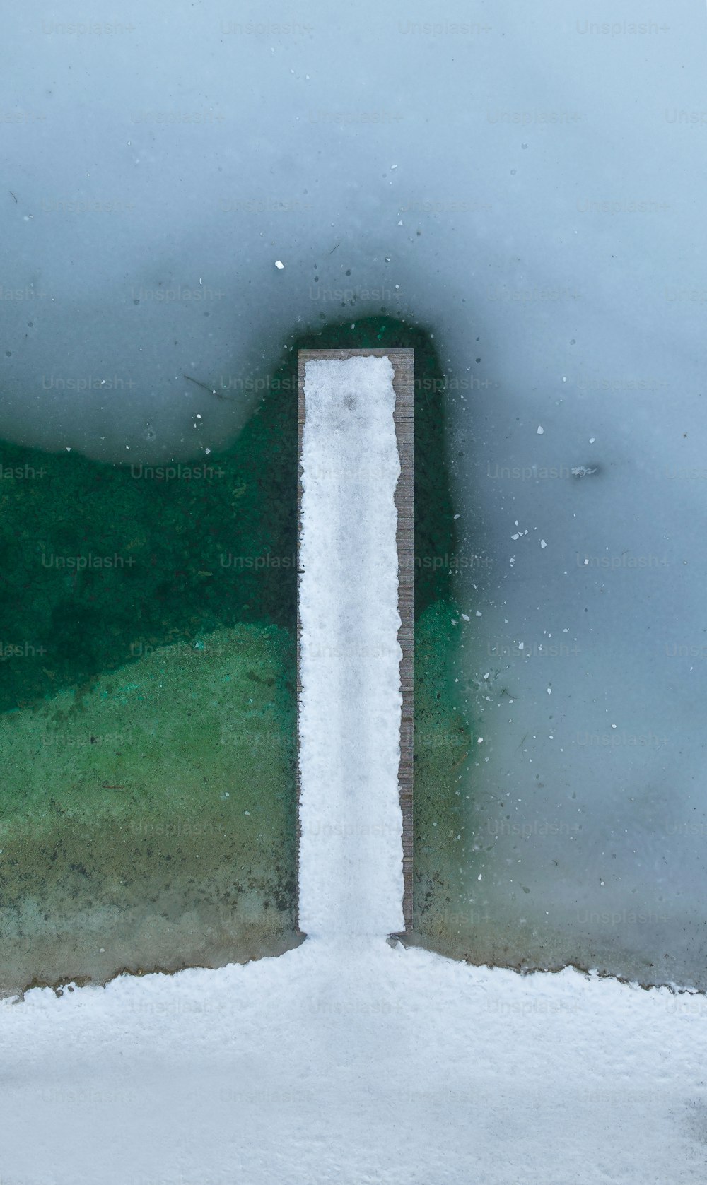 a view of snow and water from a window