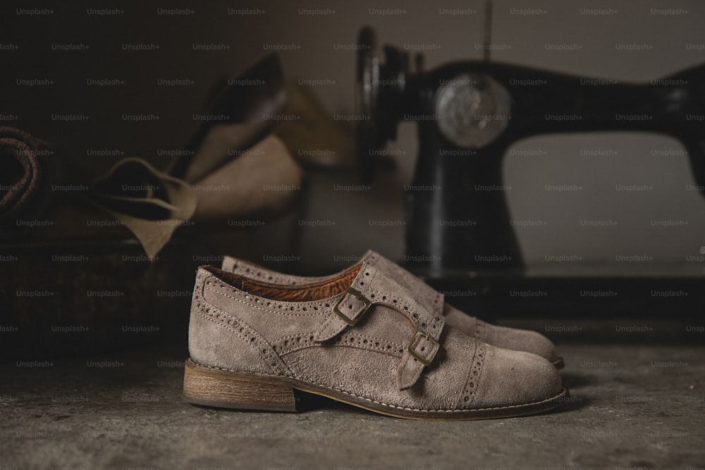 a pair of shoes sitting next to a sewing machine