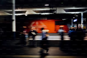 a blurry photo of people walking down a street