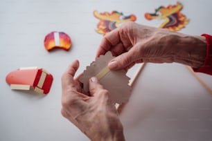 a person holding a piece of paper next to other items