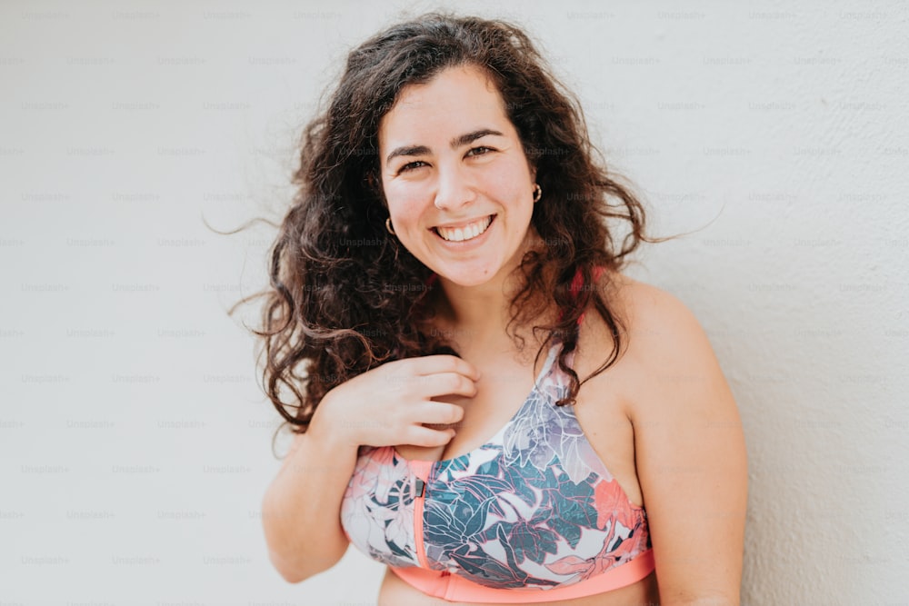 a woman in a bikini top smiling for the camera