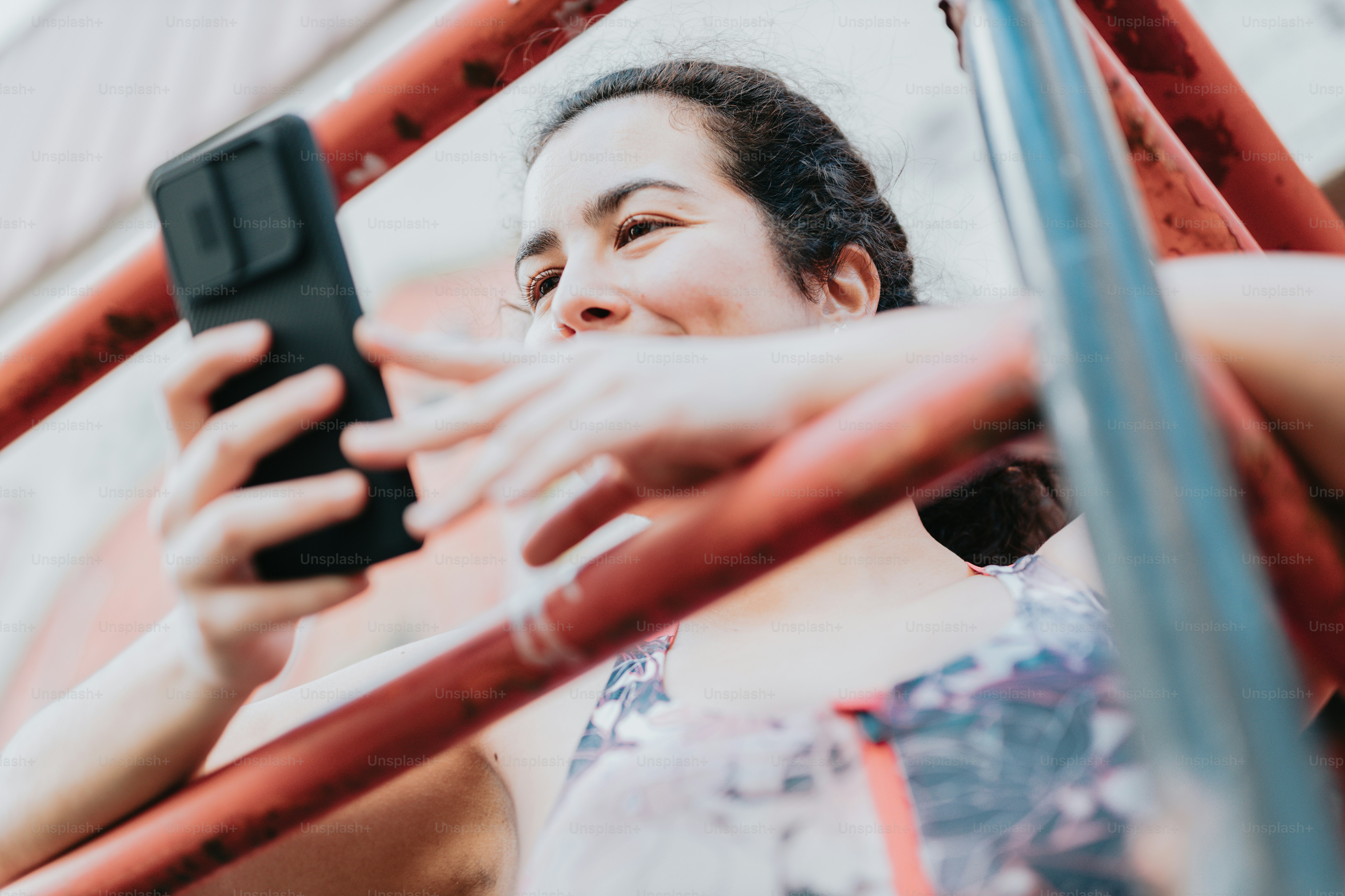 a woman looking at her cell phone while riding a bus