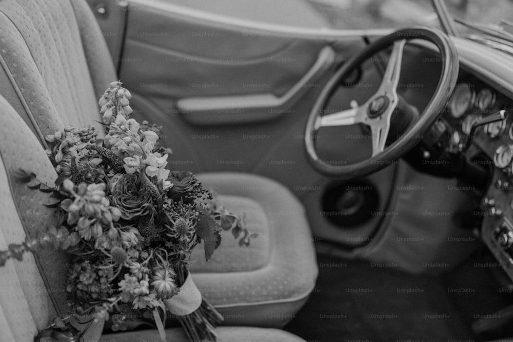 a bouquet of flowers sitting on the dash of a car