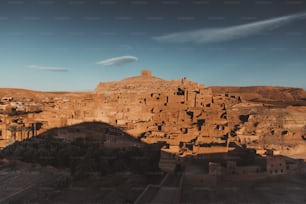 a village in the desert with a mountain in the background