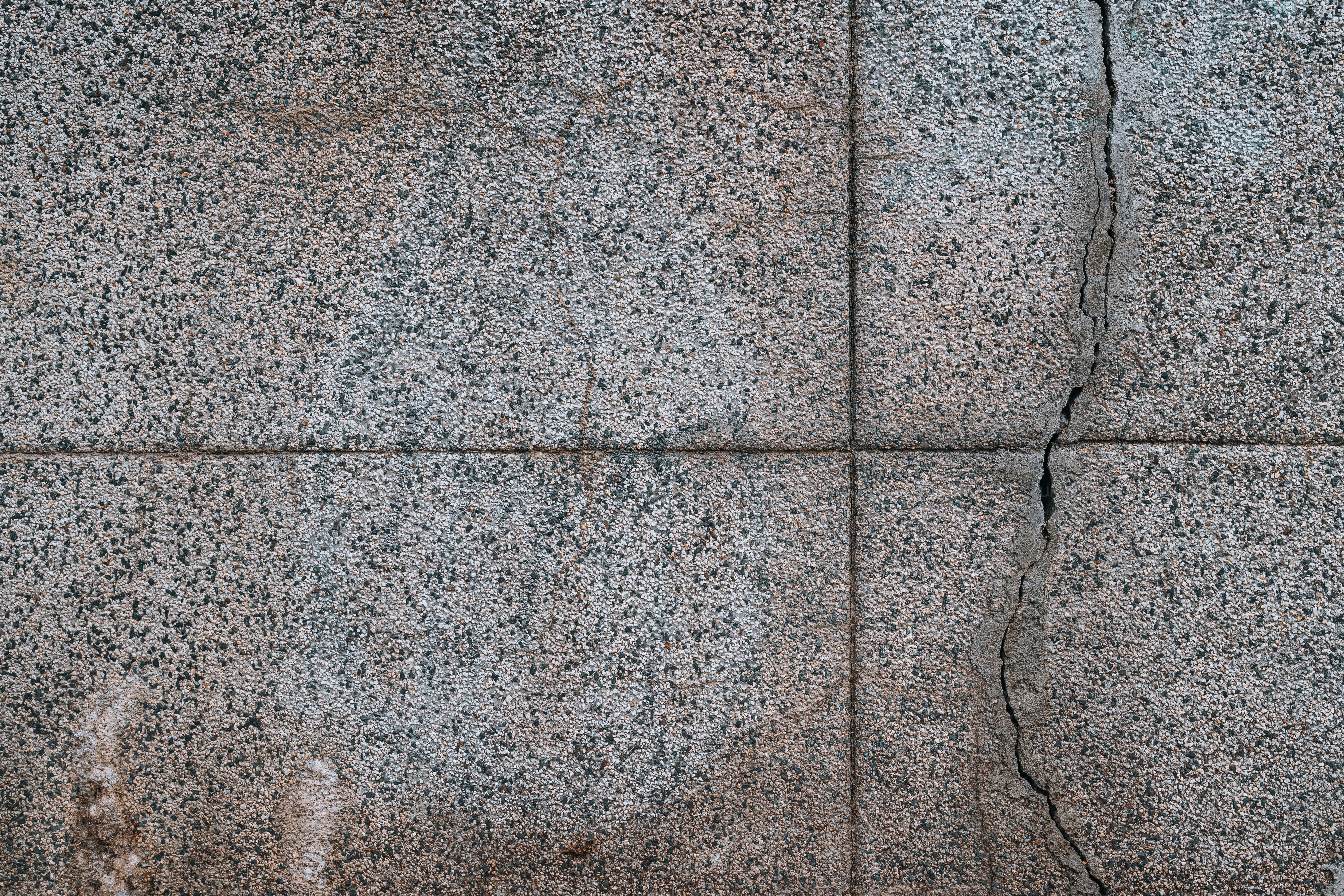 a close up of a stone wall with cracks in it