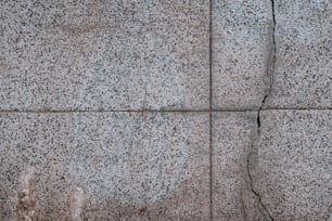 a close up of a stone wall with cracks in it