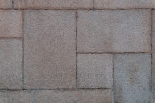 a close up of a brick wall with a clock on it