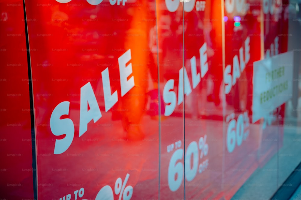 a red sale sign in a store window