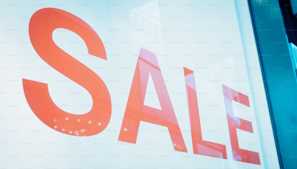 a close up of a sale sign in a store window