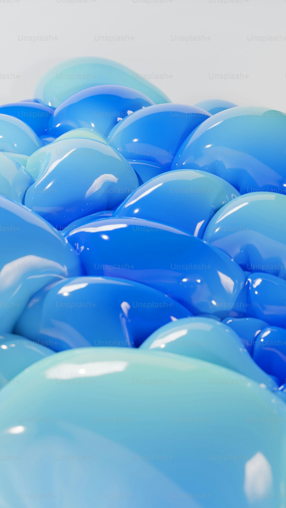 a bunch of blue balloons sitting on top of each other