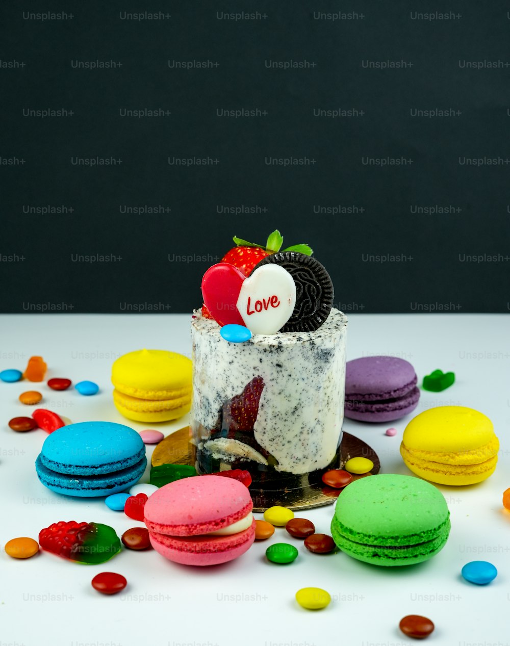 a white table topped with macaroons and cookies