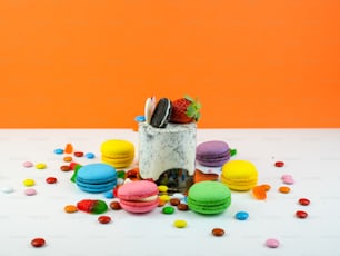 a white table topped with lots of colorful macaroni and cheese