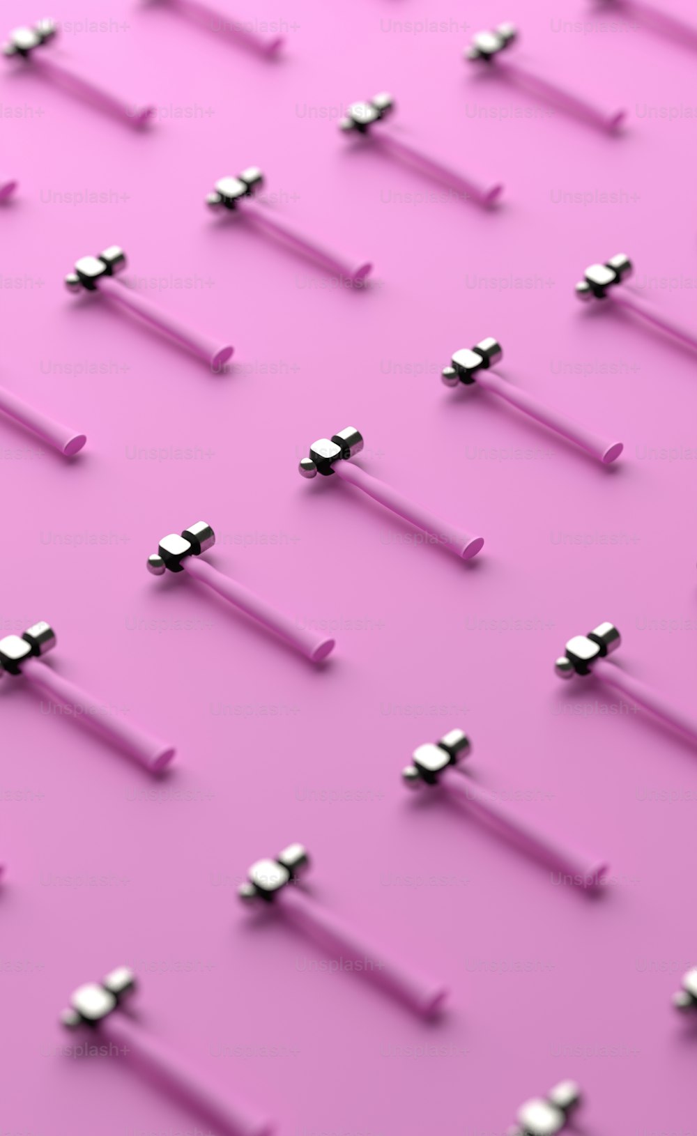 a pink background with a bunch of silver screws