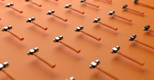 a bunch of metal objects are arranged on a orange surface