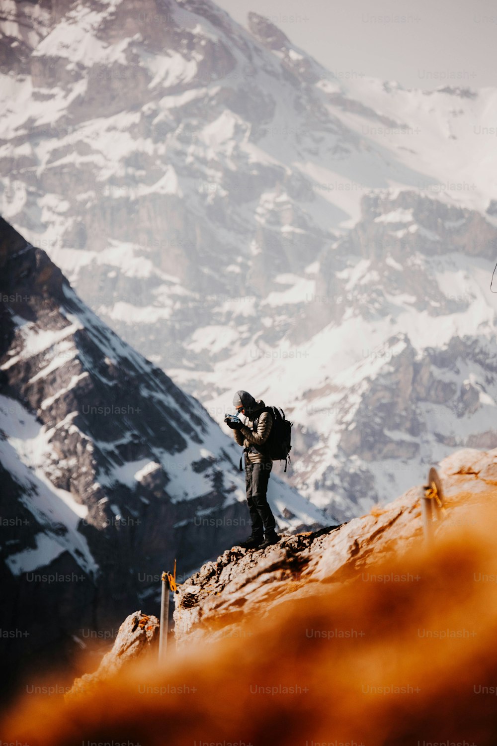 a man standing on top of a snow covered mountain