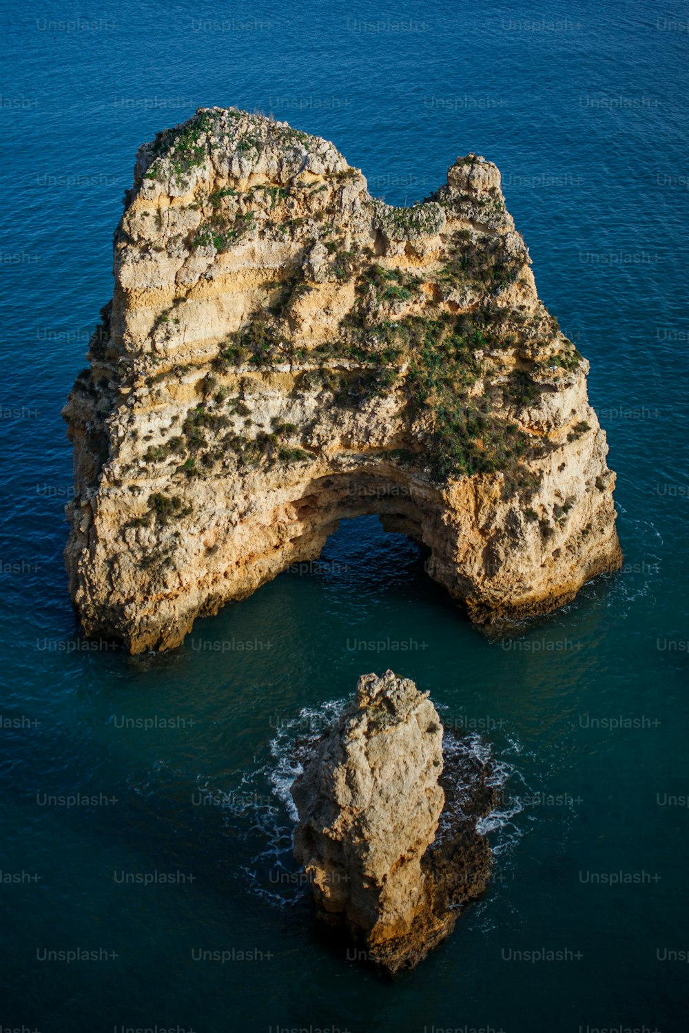 a large rock formation in the middle of the ocean