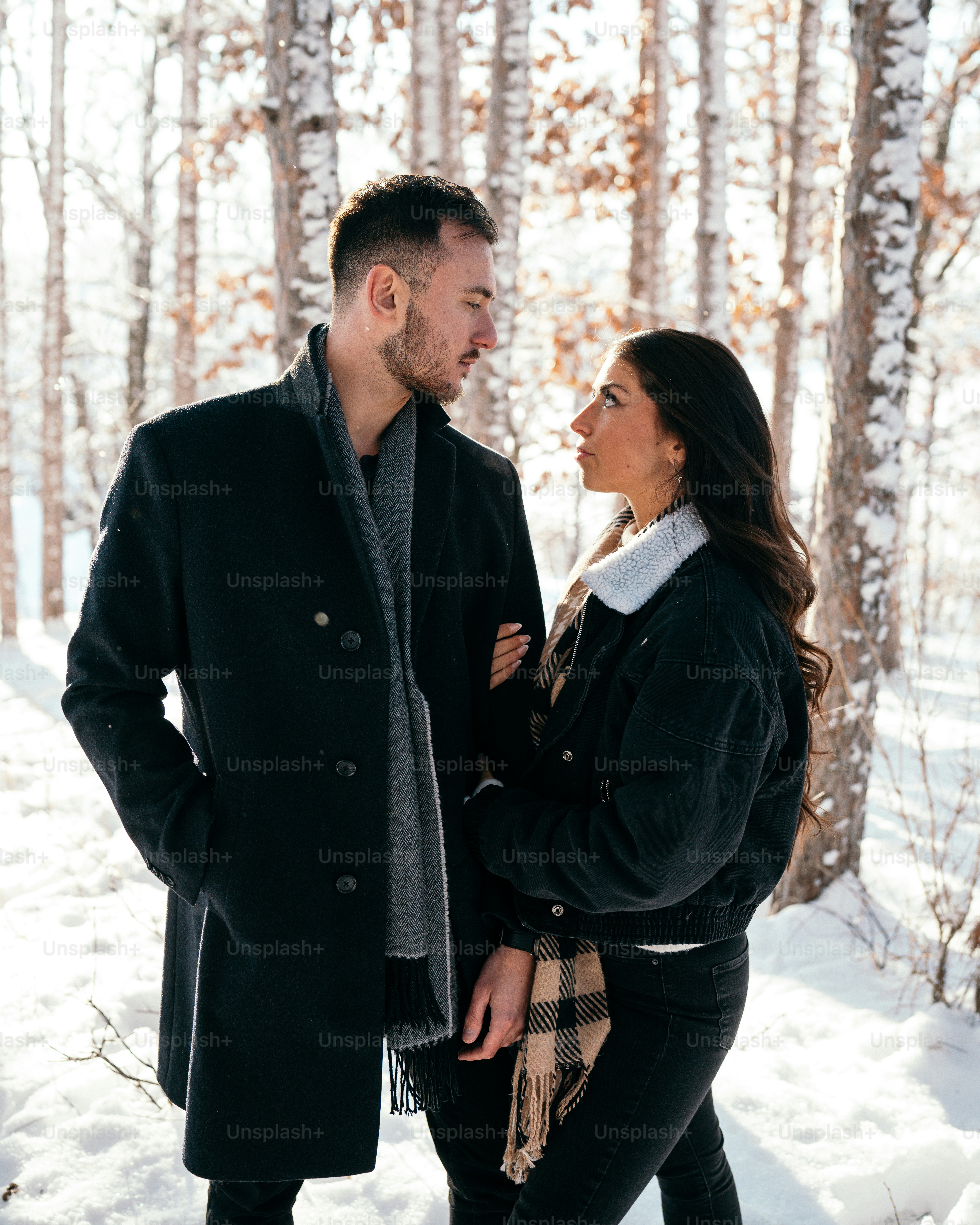 a man and a woman standing in the snow