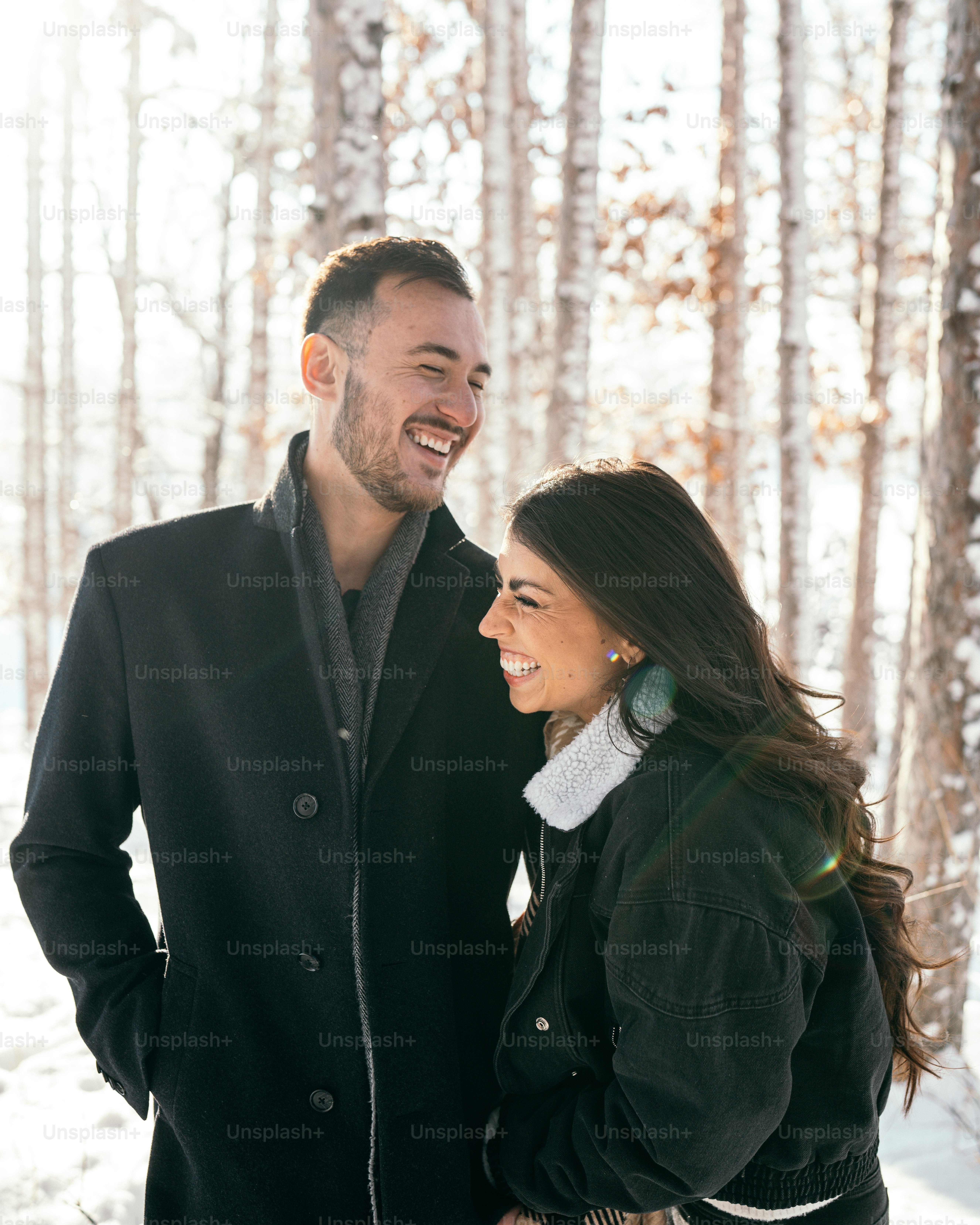 A man and a woman standing in the snow photo – Happy couple Image on ...