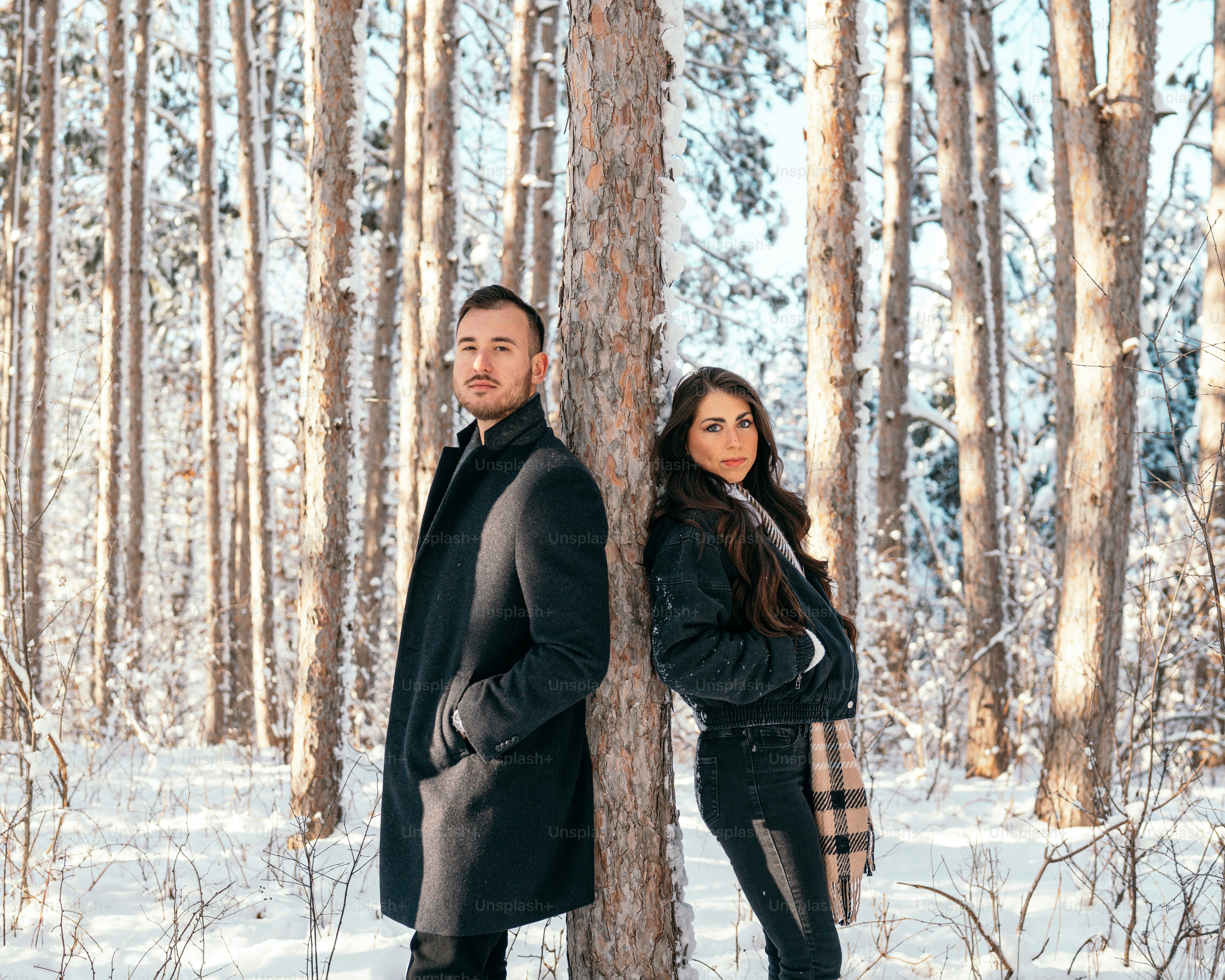 A man and a woman standing in the snow photo – Happy couple Image on ...
