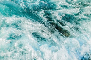 a person riding a surfboard on top of a wave