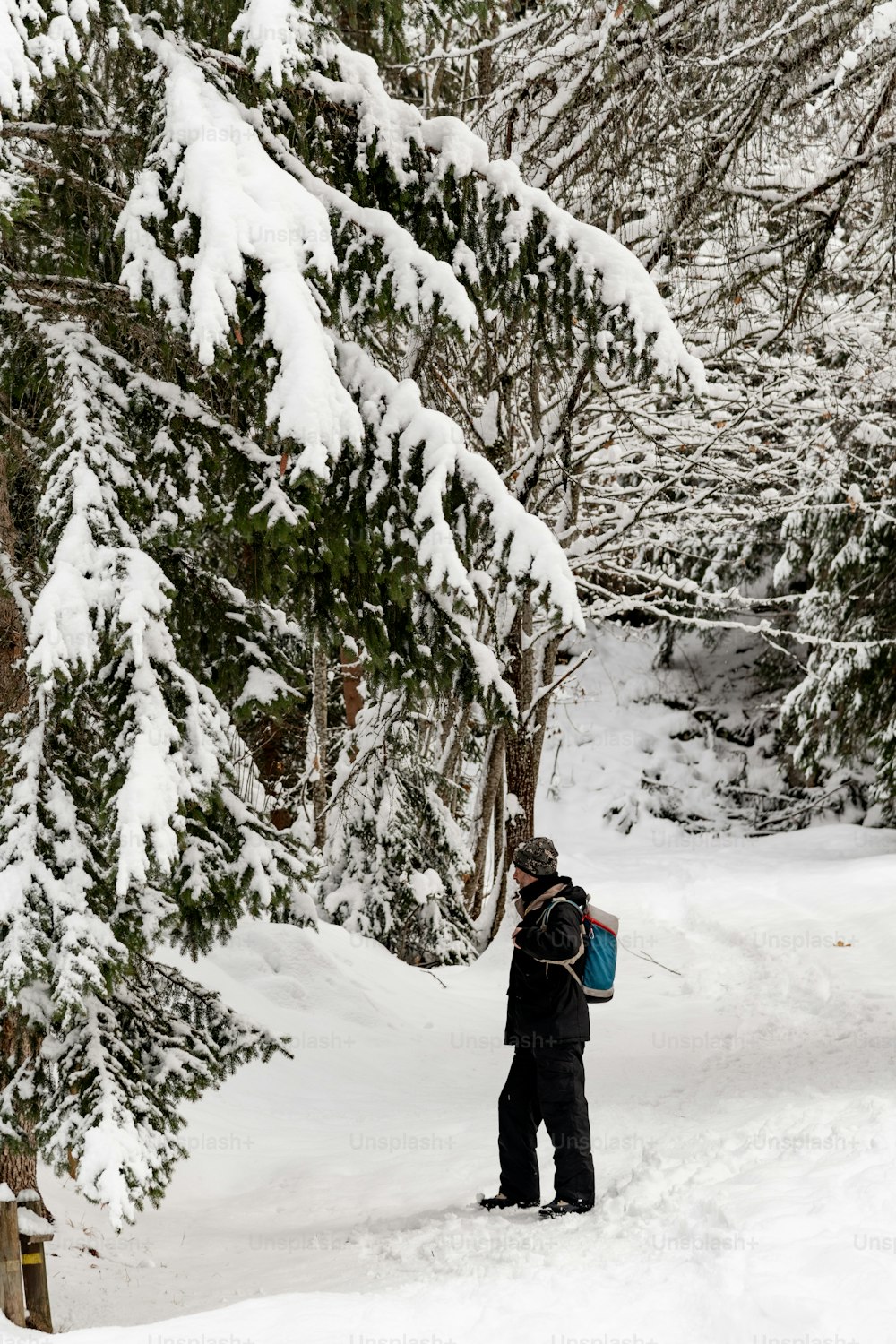 バックパックを持って雪の中を歩く人