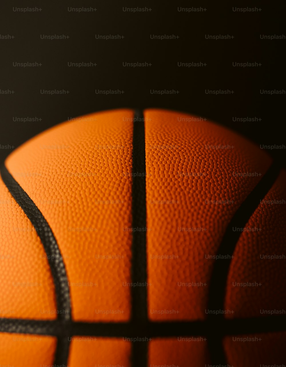 a close up of a basketball on a black background