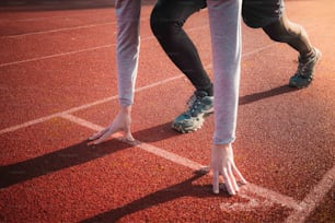 a person standing on a track with their feet on the ground