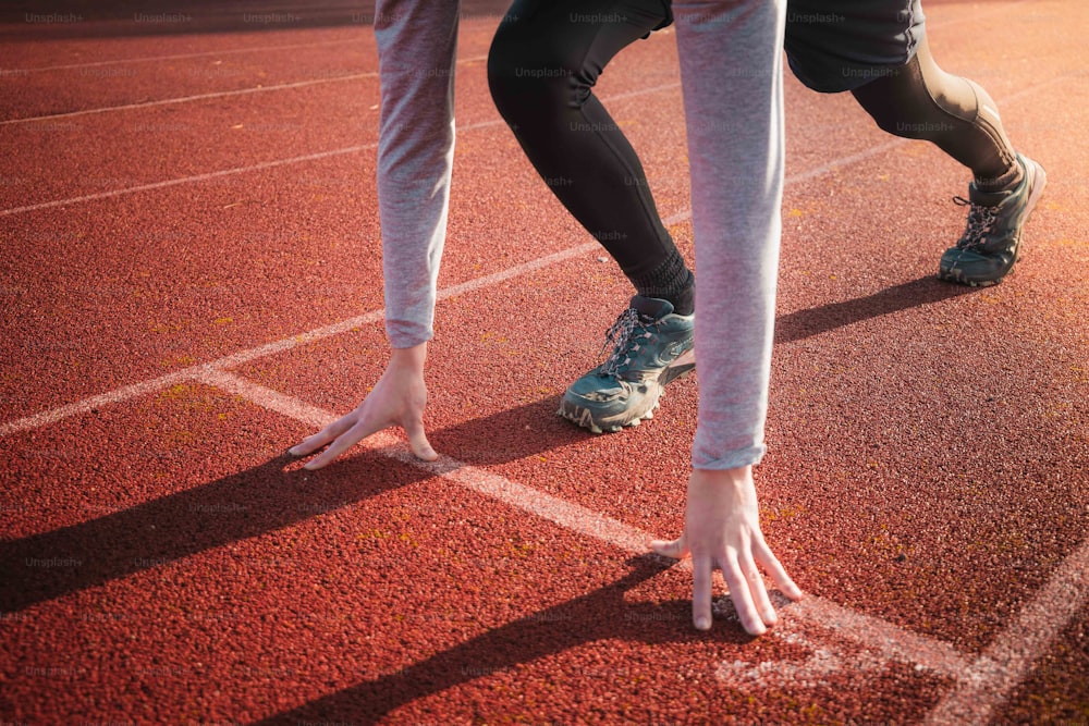 a person standing on a track with their feet on the ground